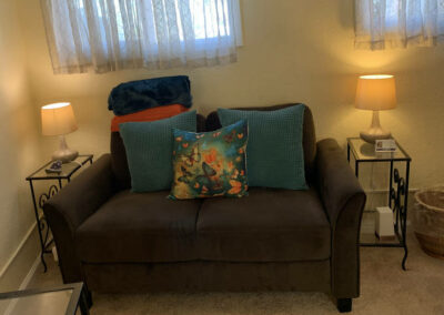 Photo of play room couch with soft and textured pillows and blankets at our Lafayette, CA office