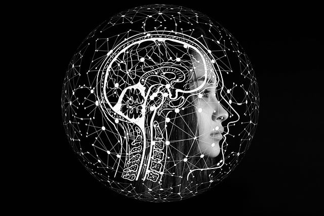 Illustration of a human head with face showing and the brain area lit up like a star map.