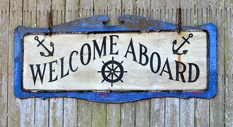 Photo of a wooden sign that reads, Welcome Aboard!